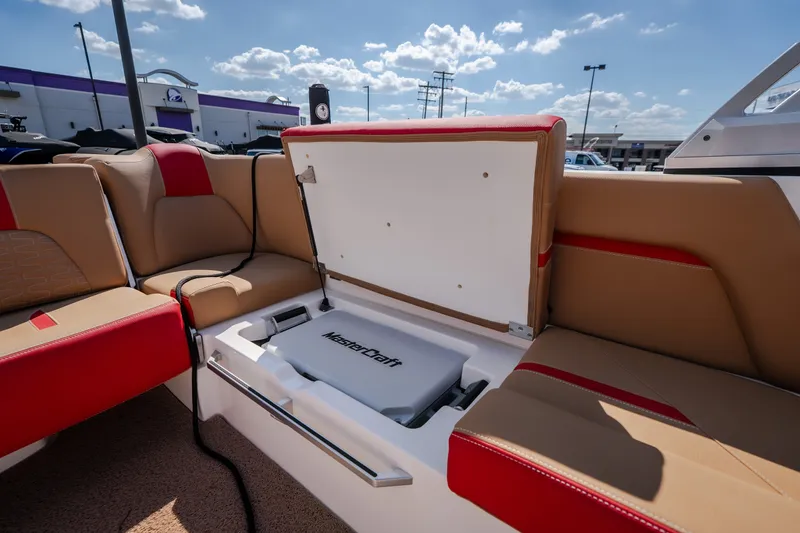 Slide: The Image of 2020 MasterCraft X26 boat interior with open storage compartment under cushioned seating. - 44
