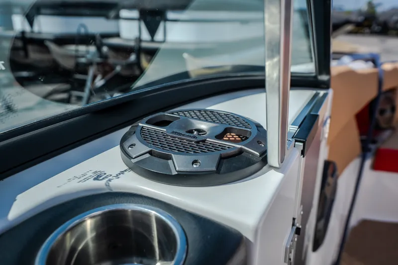 Slide: The Image of Close-up of 2020 MasterCraft X26 boat speaker and cup holder on deck. - 26