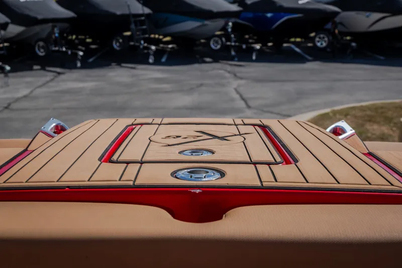 Slide: The Image of 2020 MasterCraft X26 boat deck with sleek wood finish and red accents. - 52