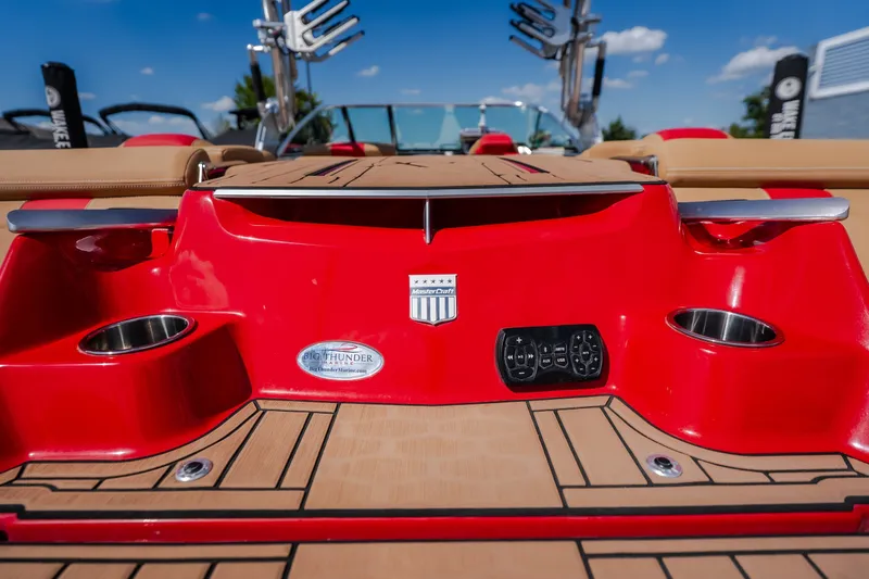 Slide: The Image of 2020 MasterCraft X26 boat with red detailing and cup holders on deck. - 14