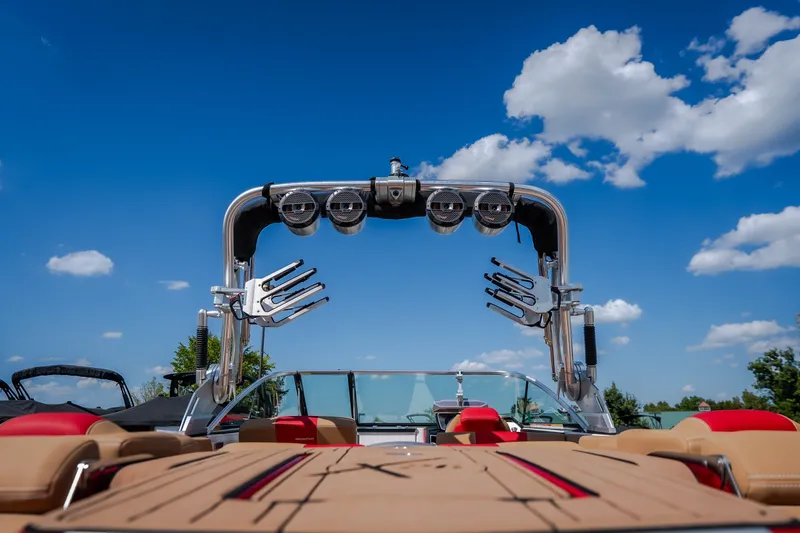 Slide: The Image of 2020 MasterCraft X26 boat with wakeboard tower under a clear blue sky. - 18
