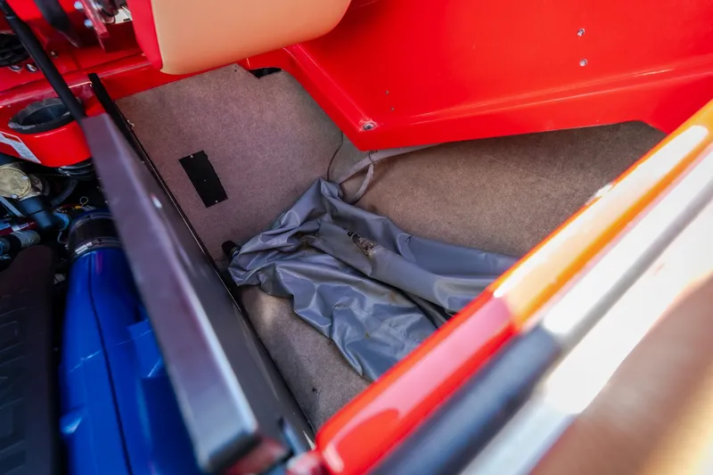 Slide: The Image of Interior view of a 2020 MasterCraft X26 boat storage compartment with red and beige accents. - 58
