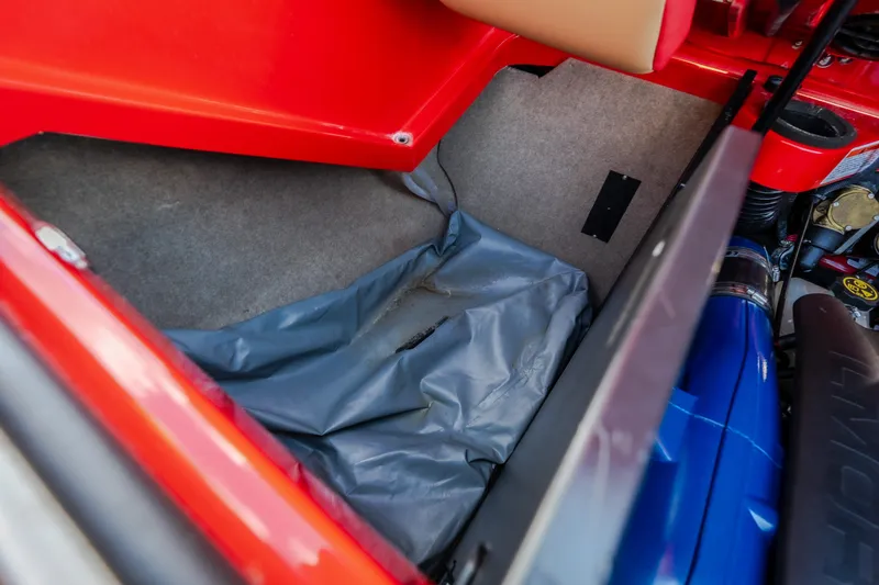 Slide: The Image of 2020 MasterCraft X26 interior storage compartment with red and blue accents. - 57