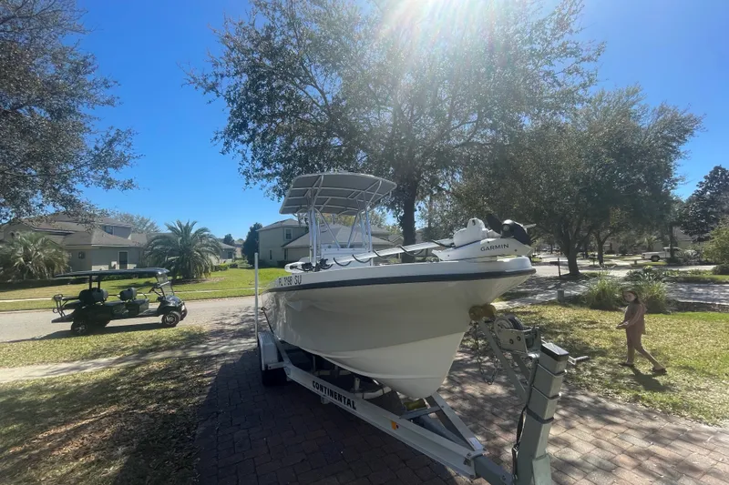 Slide: The Image of 2021 Dusky 227 Open Fisherman boat on trailer in suburban neighborhood. - 3