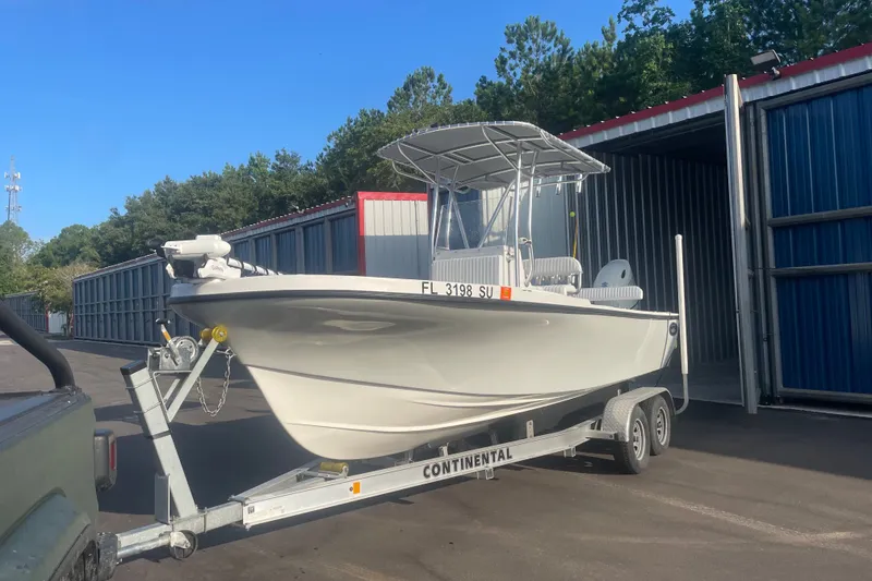 Slide: The Image of 2021 Dusky 227 Open Fisherman boat on trailer near storage units. - 4