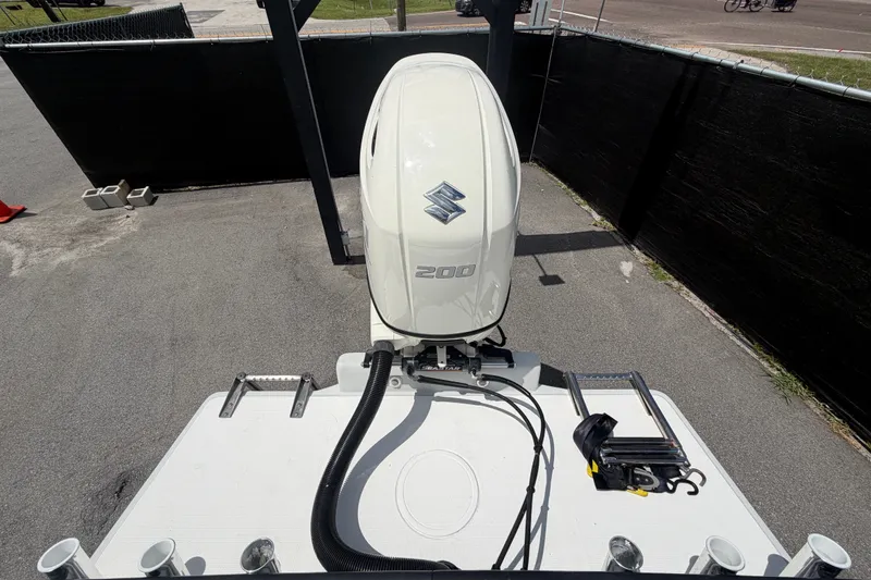 Slide: The Image of 2021 Dusky 227 Open Fisherman boat with Suzuki 200 outboard motor, parked on pavement. - 68