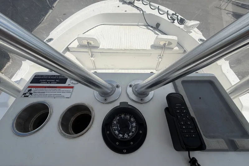Slide: The Image of Control panel of 2021 Dusky 227 Open Fisherman boat with compass and radio. - 30