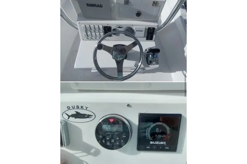 Slide: The Image of 2021 Dusky 227 Open Fisherman boat dashboard with steering wheel and Suzuki controls. - 8