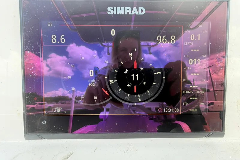 Slide: The Image of Simrad marine display on 2021 Dusky 227 Open Fisherman, showing navigation and speed data. - 23