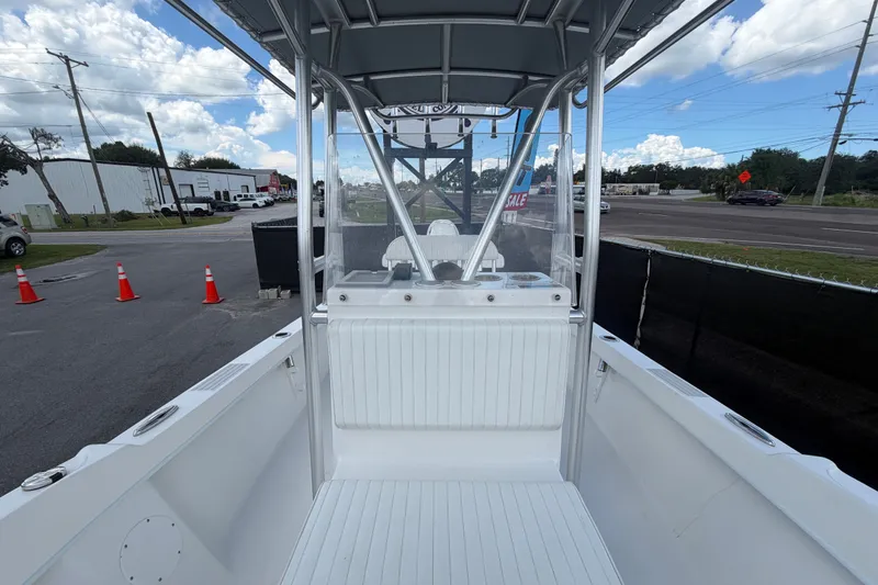 Slide: The Image of 2021 Dusky 227 Open Fisherman boat interior with T-top, parked near road. - 49