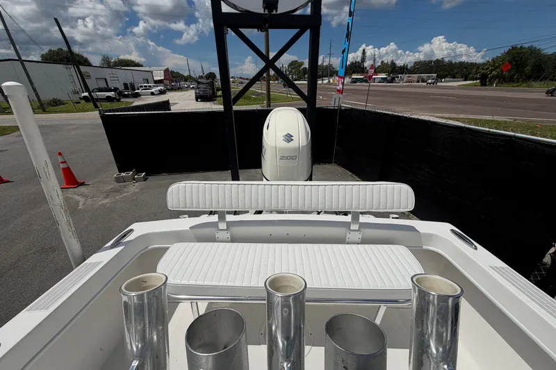 Slide: The Image of 2021 Dusky 227 Open Fisherman boat with Suzuki 200 engine, docked outdoors. - 58