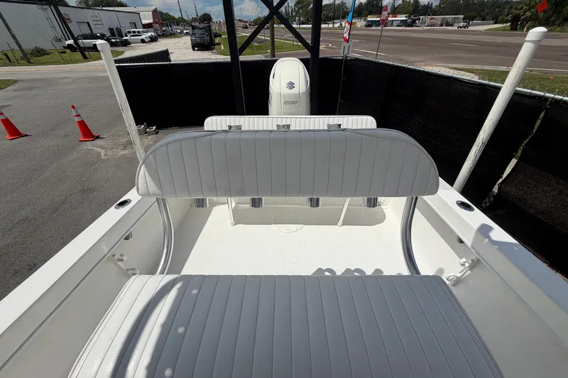 Slide: The Image of 2021 Dusky 227 Open Fisherman boat interior with white seating and Suzuki engine. - 55
