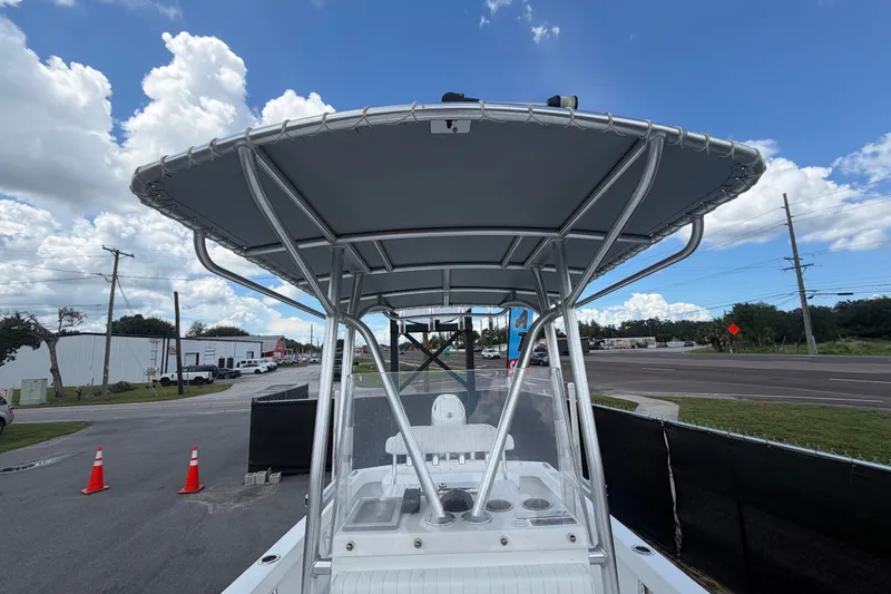 Slide: The Image of 2021 Dusky 227 Open Fisherman boat with T-top, parked on a sunny day. - 51