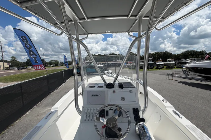 Slide: The Image of 2021 Dusky 227 Open Fisherman boat at a sales lot, featuring a Simrad console. - 20