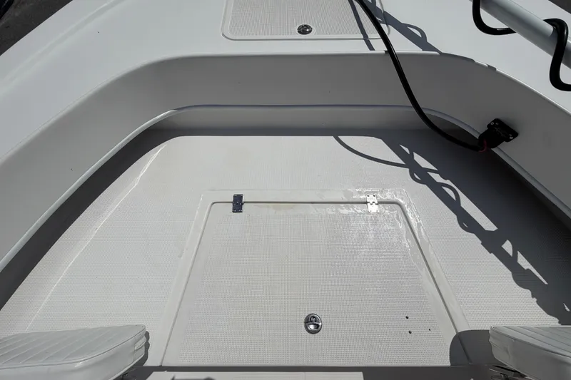 Slide: The Image of 2021 Dusky 227 Open Fisherman boat deck with storage hatch and seating. - 35