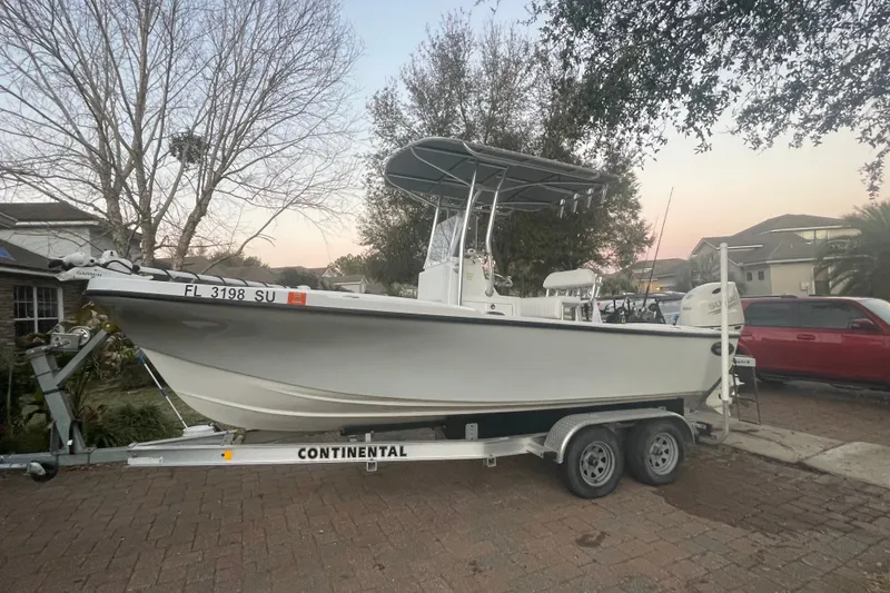 Slide: The Image of 2021 Dusky 227 Open Fisherman boat on trailer, parked in residential driveway. - 2