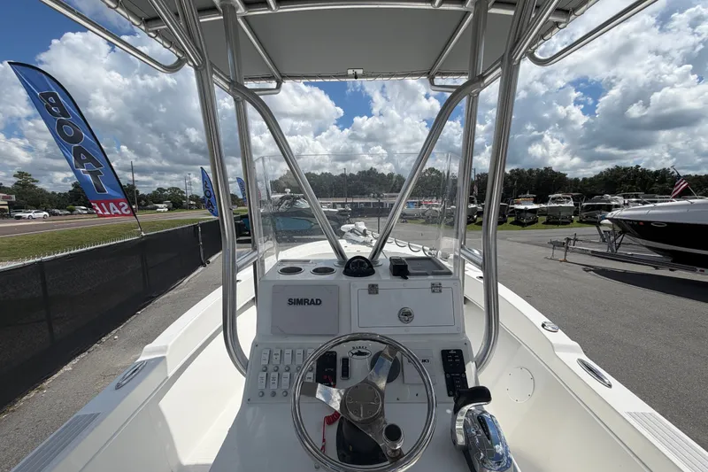 Slide: The Image of 2021 Dusky 227 Open Fisherman boat dashboard with steering wheel and controls. - 19