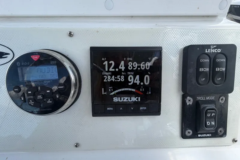 Slide: The Image of Control panel of a 2021 Dusky 227 Open Fisherman boat with Suzuki engine display. - 26