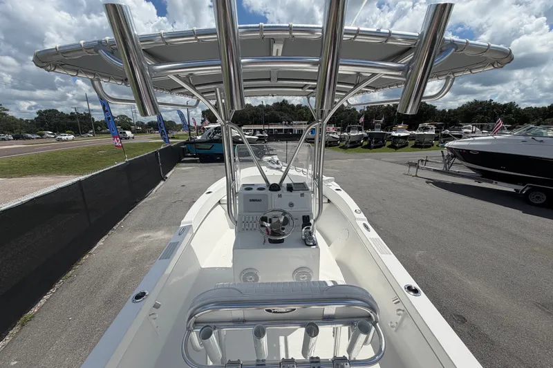 Slide: The Image of 2021 Dusky 227 Open Fisherman boat with T-top, parked in a dealership lot. - 17