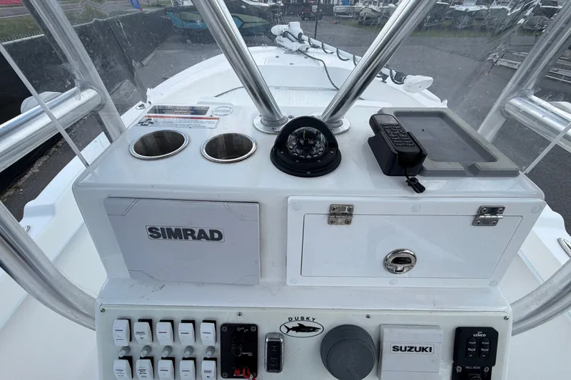 Slide: The Image of 2021 Dusky 227 Open Fisherman boat console with Simrad electronics and Suzuki controls. - 21