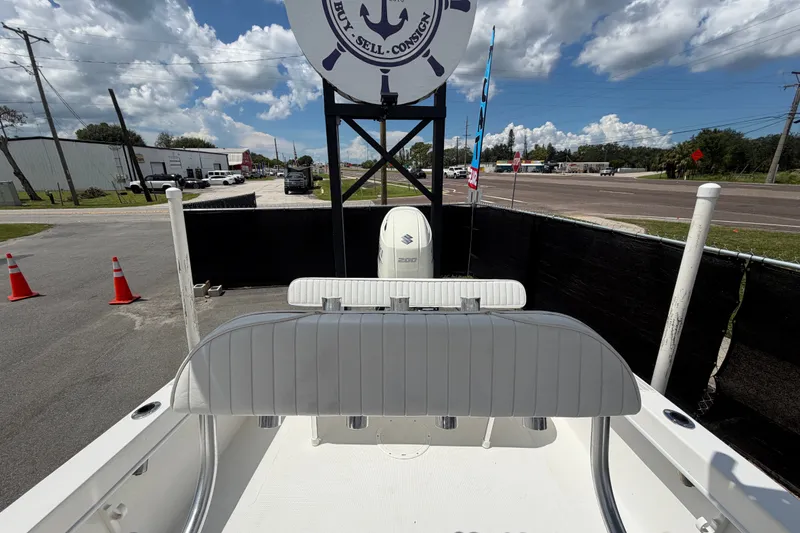 Slide: The Image of 2021 Dusky 227 Open Fisherman boat displayed outdoors under a sunny sky. - 57