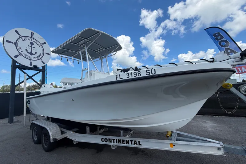 The Image of 2021 Dusky 227 Open Fisherman boat on trailer under blue sky. - 0