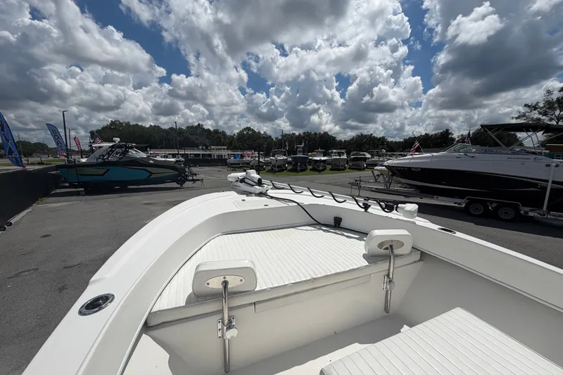 Slide: The Image of 2021 Dusky 227 Open Fisherman boat displayed outdoors under cloudy sky. - 32