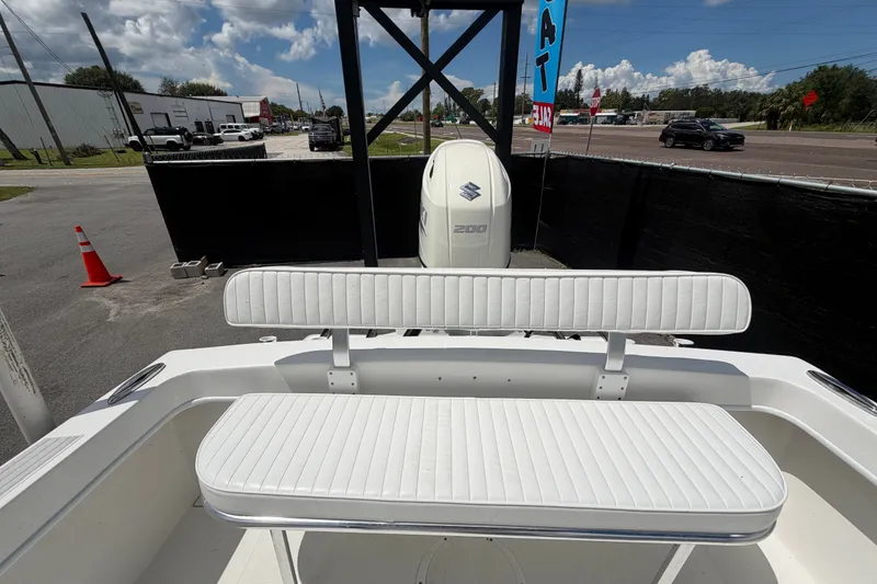 Slide: The Image of 2021 Dusky 227 Open Fisherman boat with Suzuki 200 engine, white seating, outdoor display. - 59