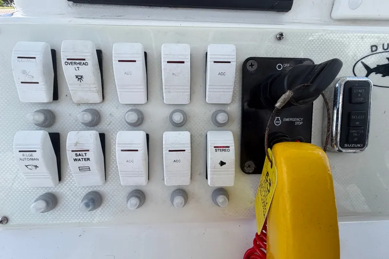 Slide: The Image of Control panel of a 2021 Dusky 227 Open Fisherman boat with switches and ignition. - 24