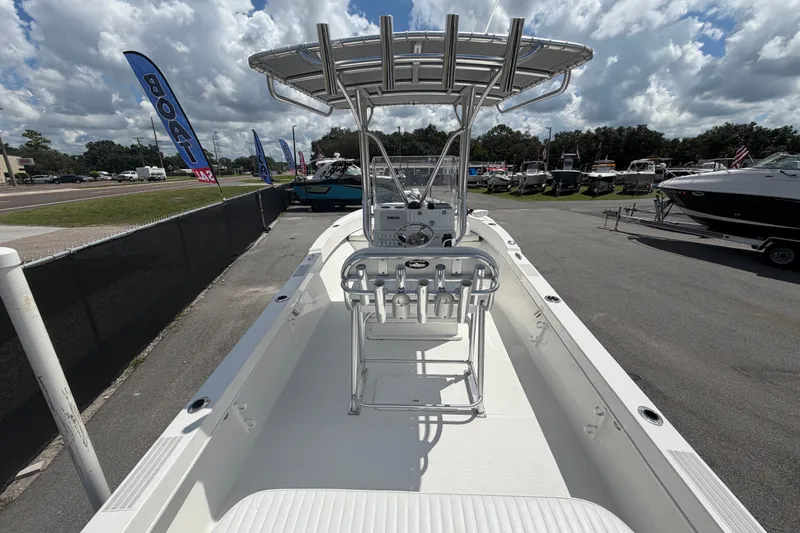 Slide: The Image of 2021 Dusky 227 Open Fisherman boat displayed outdoors under a cloudy sky. - 14