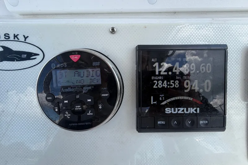 Slide: The Image of Dashboard of 2021 Dusky 227 Open Fisherman with Audiopipe and Suzuki displays. - 25