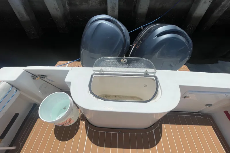 Slide: The Image of 2007 Contender 35 Side Console boat with dual engines and livewell on deck. - 12