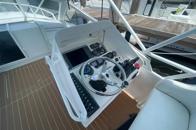 Slide: The Image of 2007 Contender 35 Side Console helm with steering wheel and navigation controls. - 4