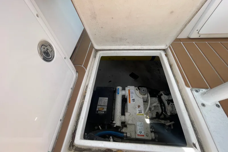 Slide: The Image of Open engine compartment of 2007 Contender 35 Side Console boat, showing mechanical components. - 10