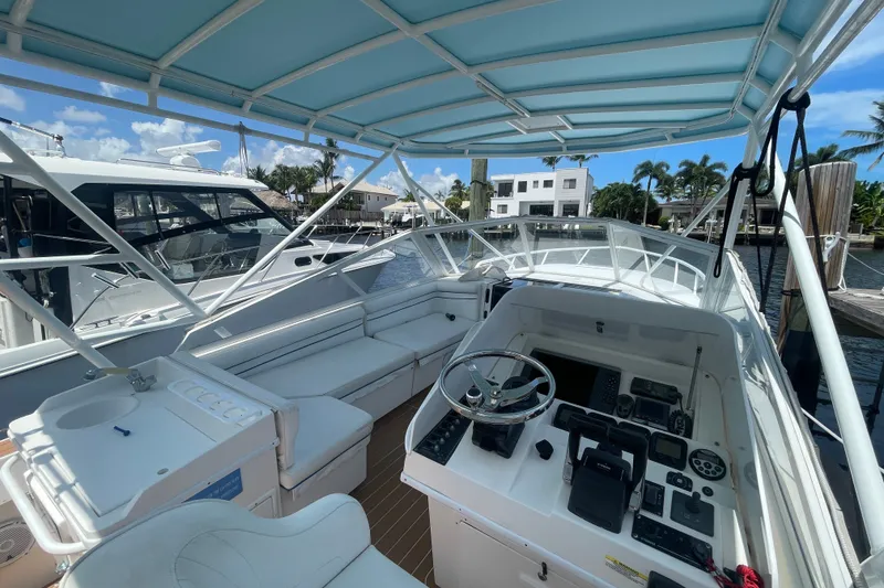 Slide: The Image of 2007 Contender 35 Side Console boat interior with helm, seating, and marina view. - 3
