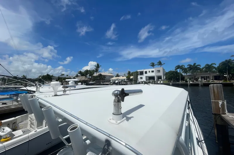Slide: The Image of 2007 Contender 35 Side Console boat docked under a clear blue sky. - 18