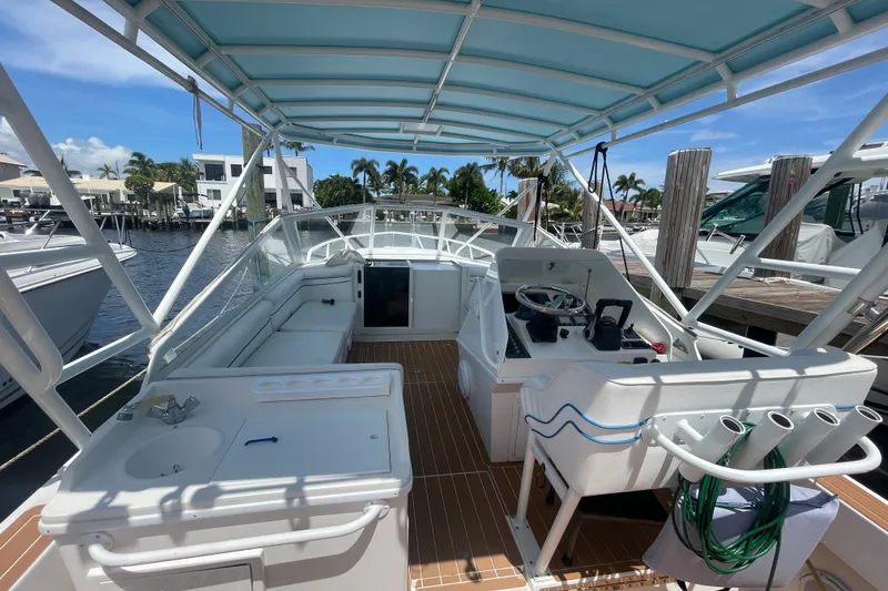 Slide: The Image of 2007 Contender 35 Side Console boat interior with helm, seating, and dockside view. - 6