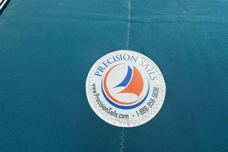 Slide: The Image of Precision Sails logo on Hunter 420 sailboat, 1999 model, with contact details. - 28