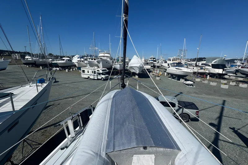Slide: The Image of Sailboats in a marina, featuring a 1999 Hunter 420, under a clear blue sky. - 26