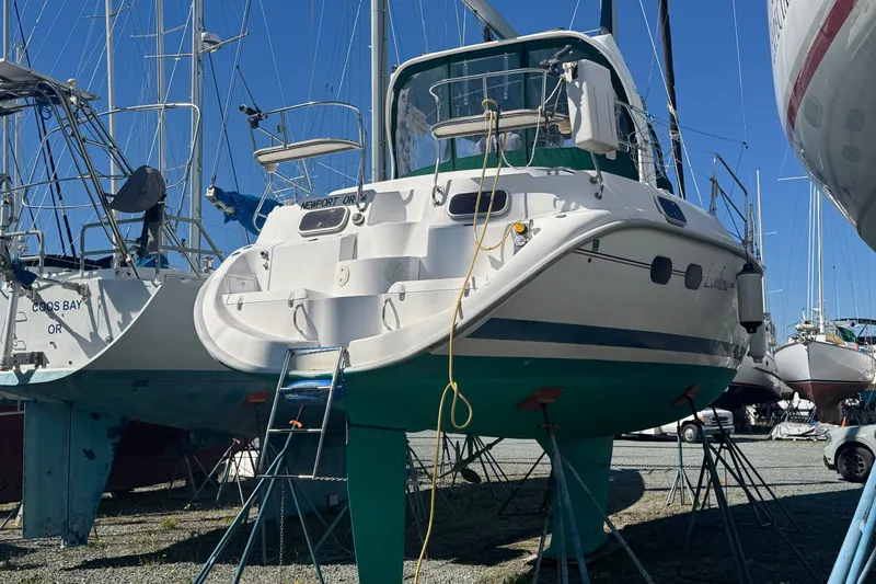 Slide: The Image of Hunter 420 sailboat from 1999 on stands in a marina, surrounded by other boats. - 31
