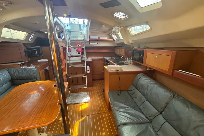 Slide: The Image of Interior of a 1999 Hunter 420 sailboat with wood finishes and modern amenities. - 10
