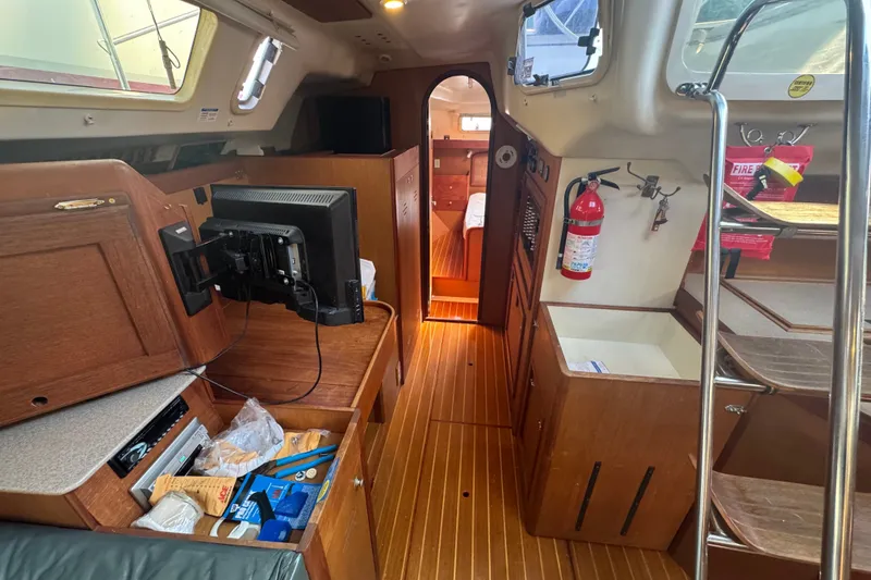 Slide: The Image of Interior of a 1999 Hunter 420 sailboat with wood finish and modern amenities. - 15