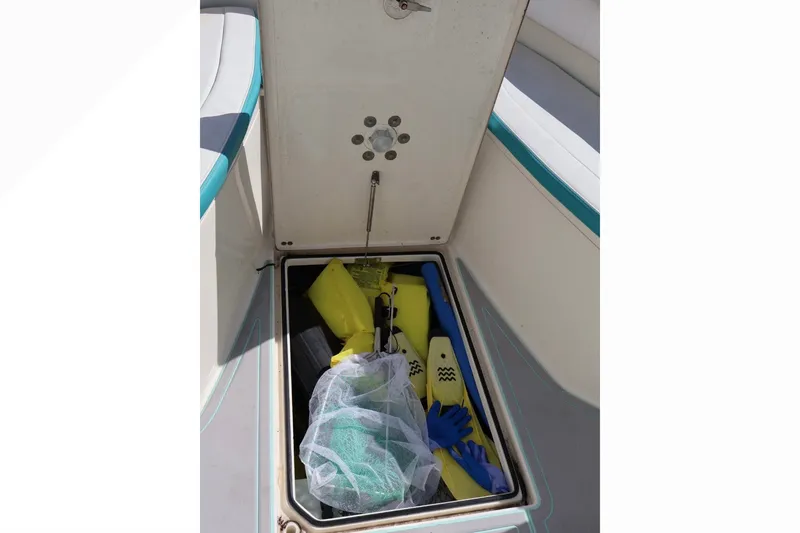 Slide: The Image of Storage compartment on a 2015 Cobia 296 Center Console boat with diving gear. - 14