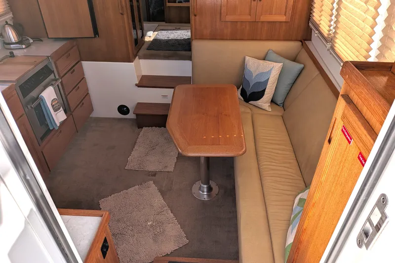 Slide: The Image of Cozy interior of 2010 Nordic Tug 32 with dining area and kitchen. - 12