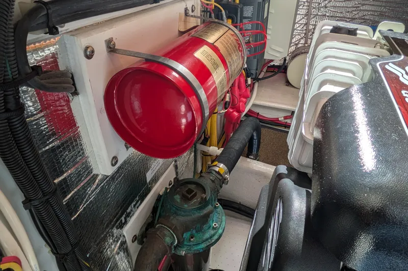 Slide: The Image of Engine room of a 2010 Nordic Tug 32 with fire extinguisher and mechanical components. - 49