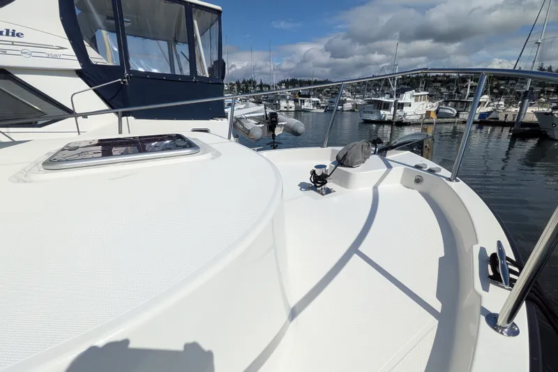 Slide: The Image of 2010 Nordic Tug 32 docked at a marina, showcasing its sleek deck design. - 5