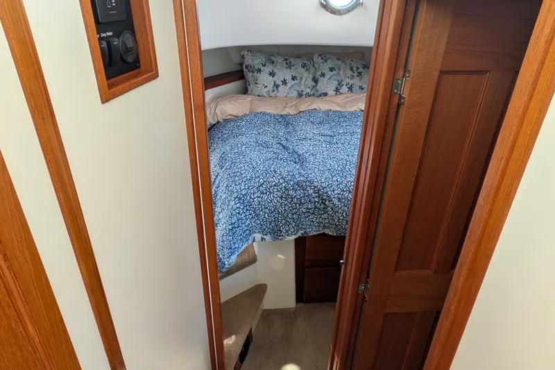 Slide: The Image of Cozy cabin interior of 2010 Nordic Tug 32 with floral bedding and wooden accents. - 37