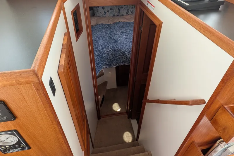 Slide: The Image of Interior view of 2010 Nordic Tug 32, featuring wooden stairs and cozy cabin entrance. - 36
