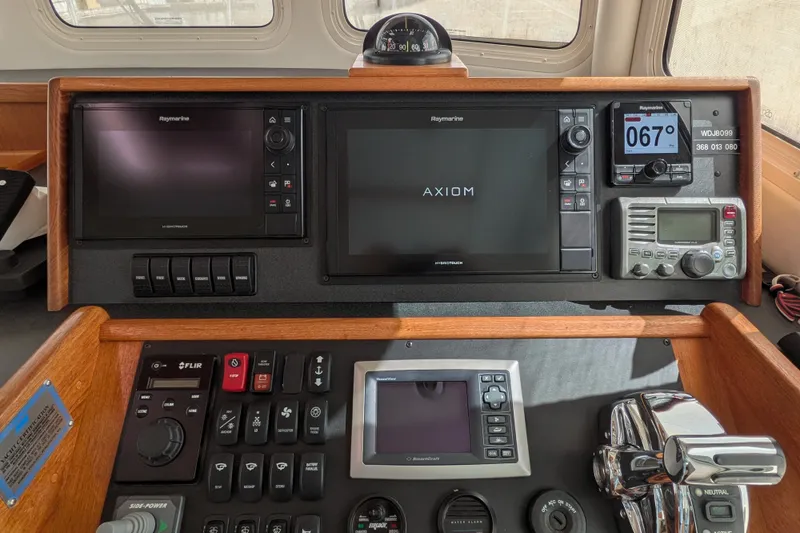 Slide: The Image of Control panel of a 2010 Nordic Tug 32 with navigation and communication equipment. - 28