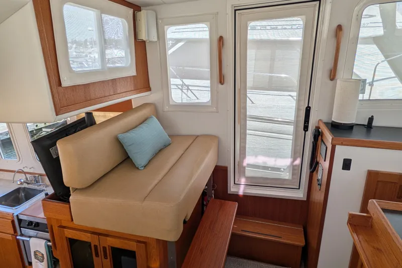 Slide: The Image of Interior of a 2010 Nordic Tug 32, featuring a cozy seating area and modern amenities. - 35